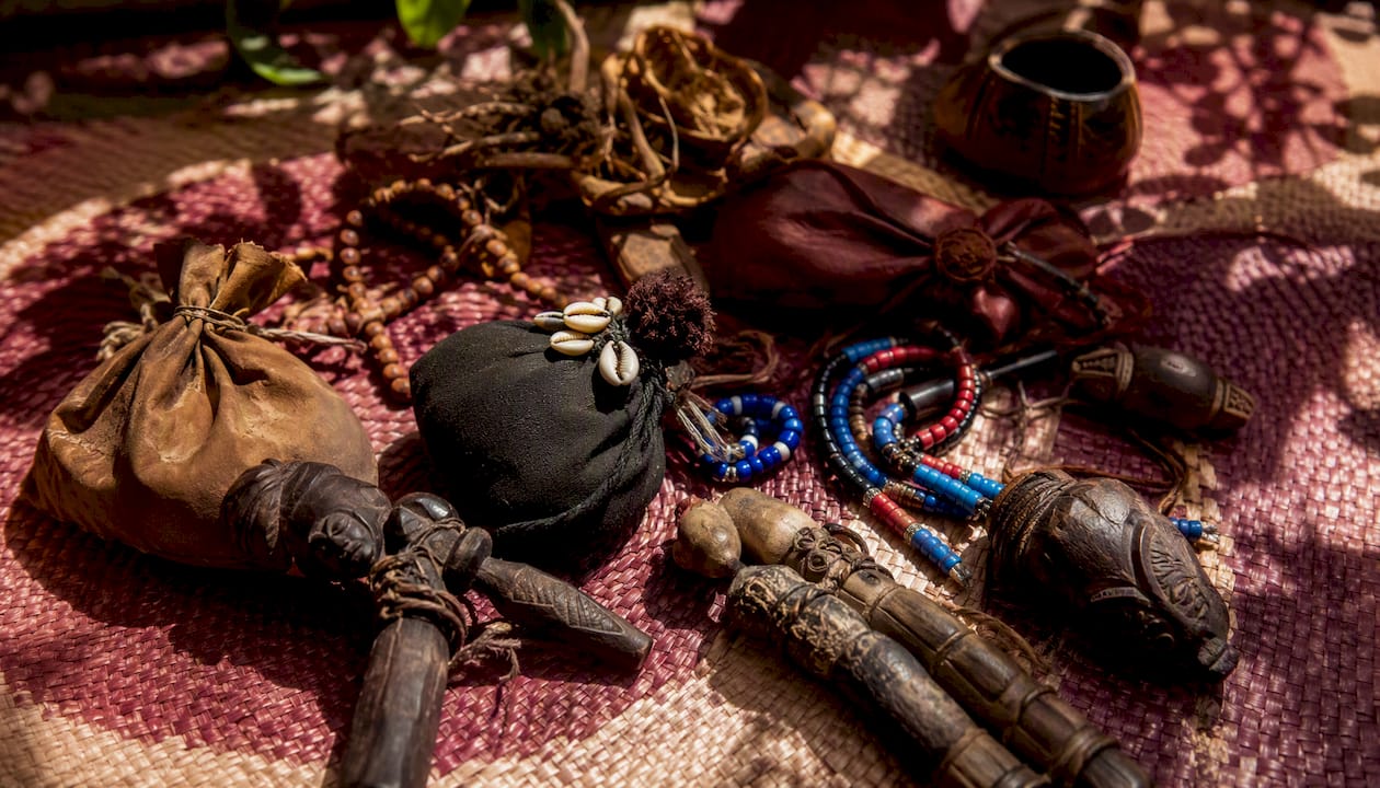 Assorted West African prosperity charms and amulets on cloth
