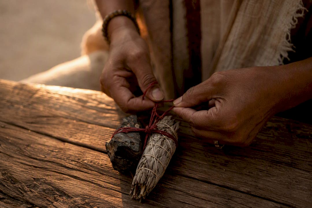 Hands tying red cord in binding ritual