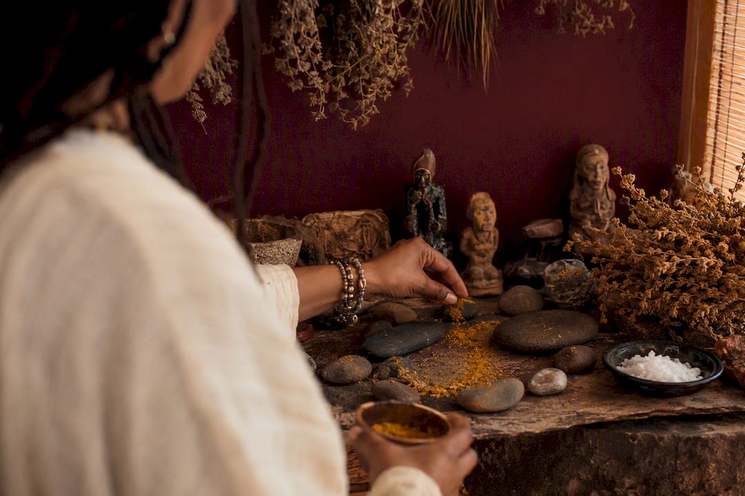 Hands arranging ancestral money ritual objects