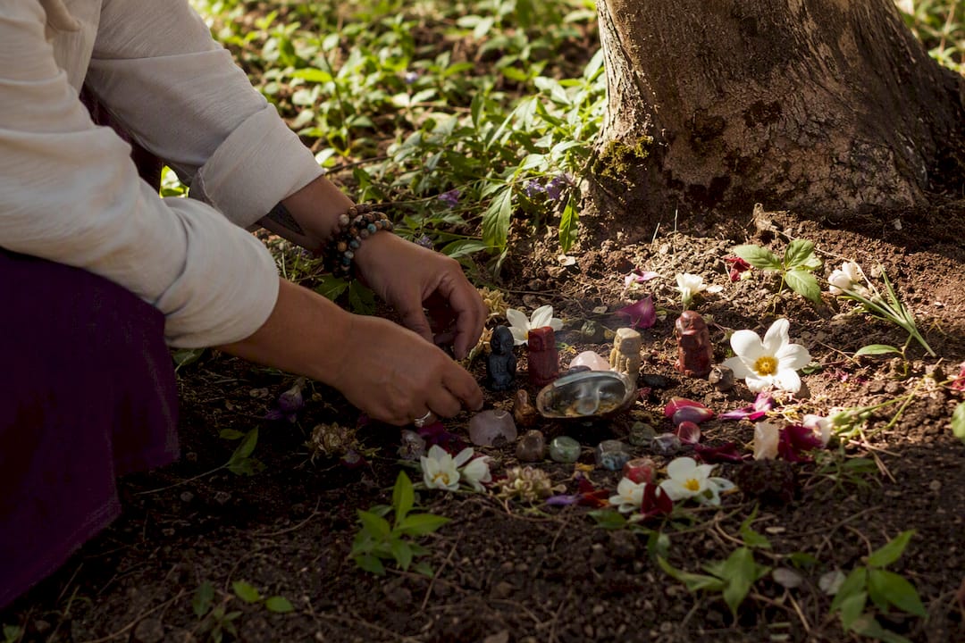Hands customizing traditional ritual altar