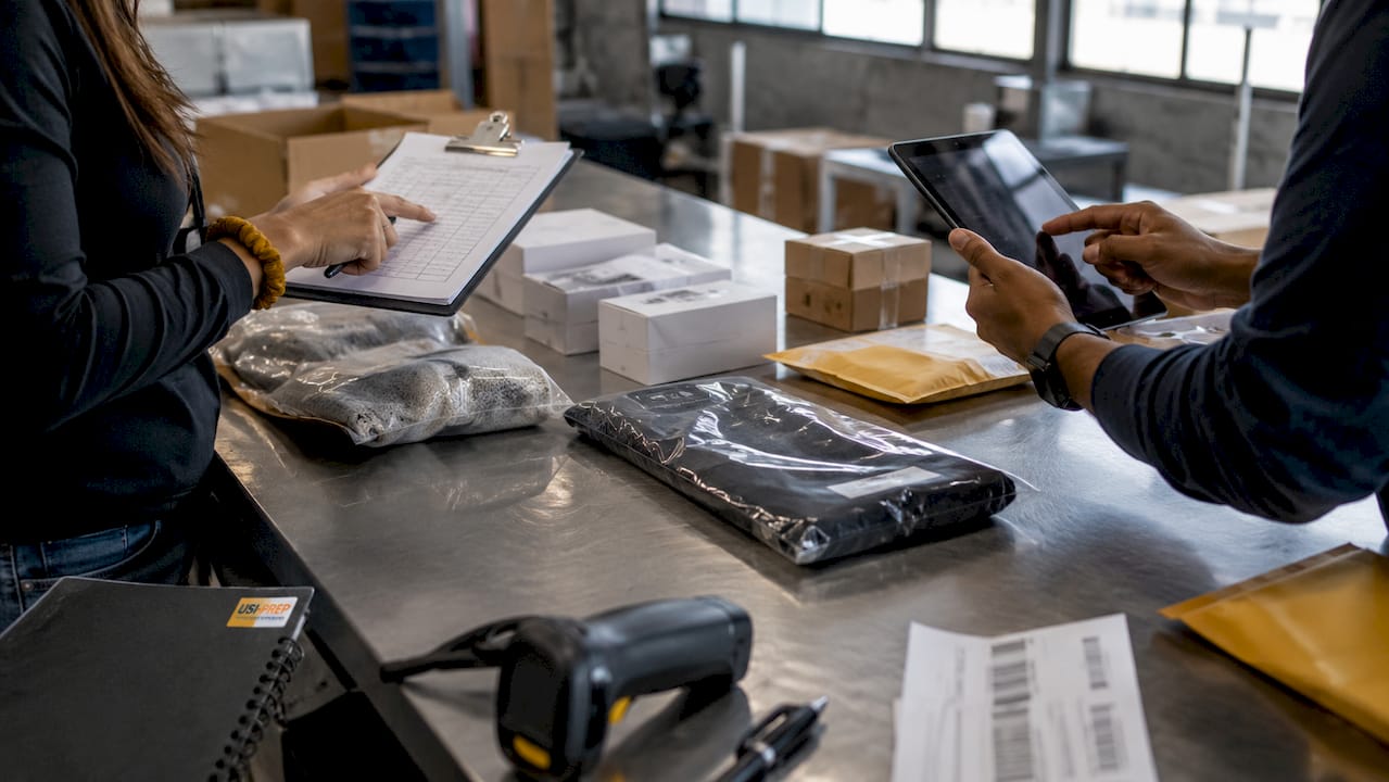 Hands inspecting returned items with documentation