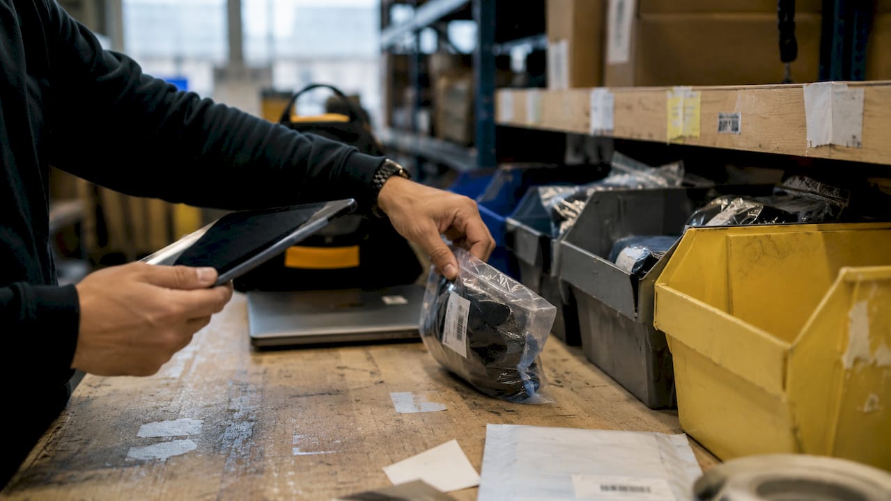 Hands scanning and sorting returned ecommerce products