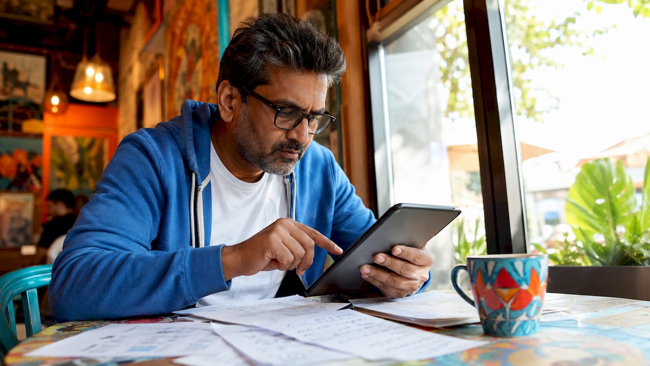Man reviewing online reviews on tablet
