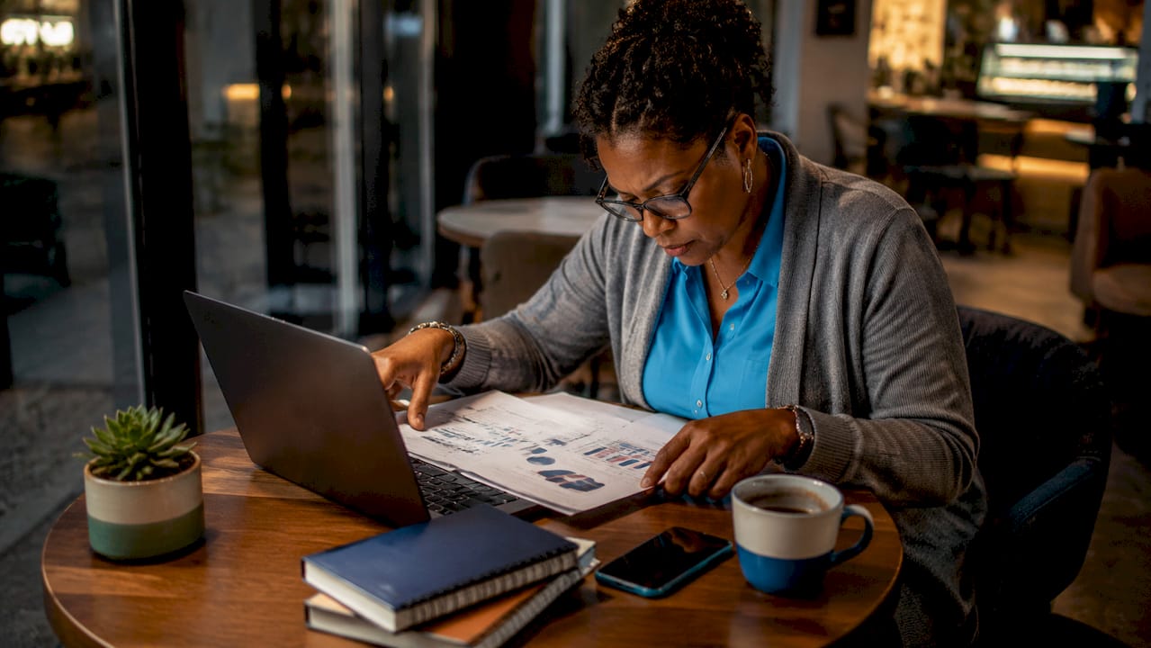Woman reviewing social media analytics at desk