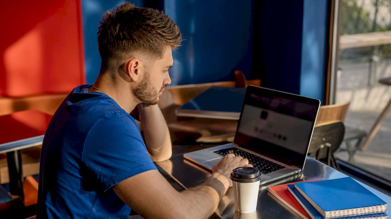 Person scrolling Instagram profile on laptop at home