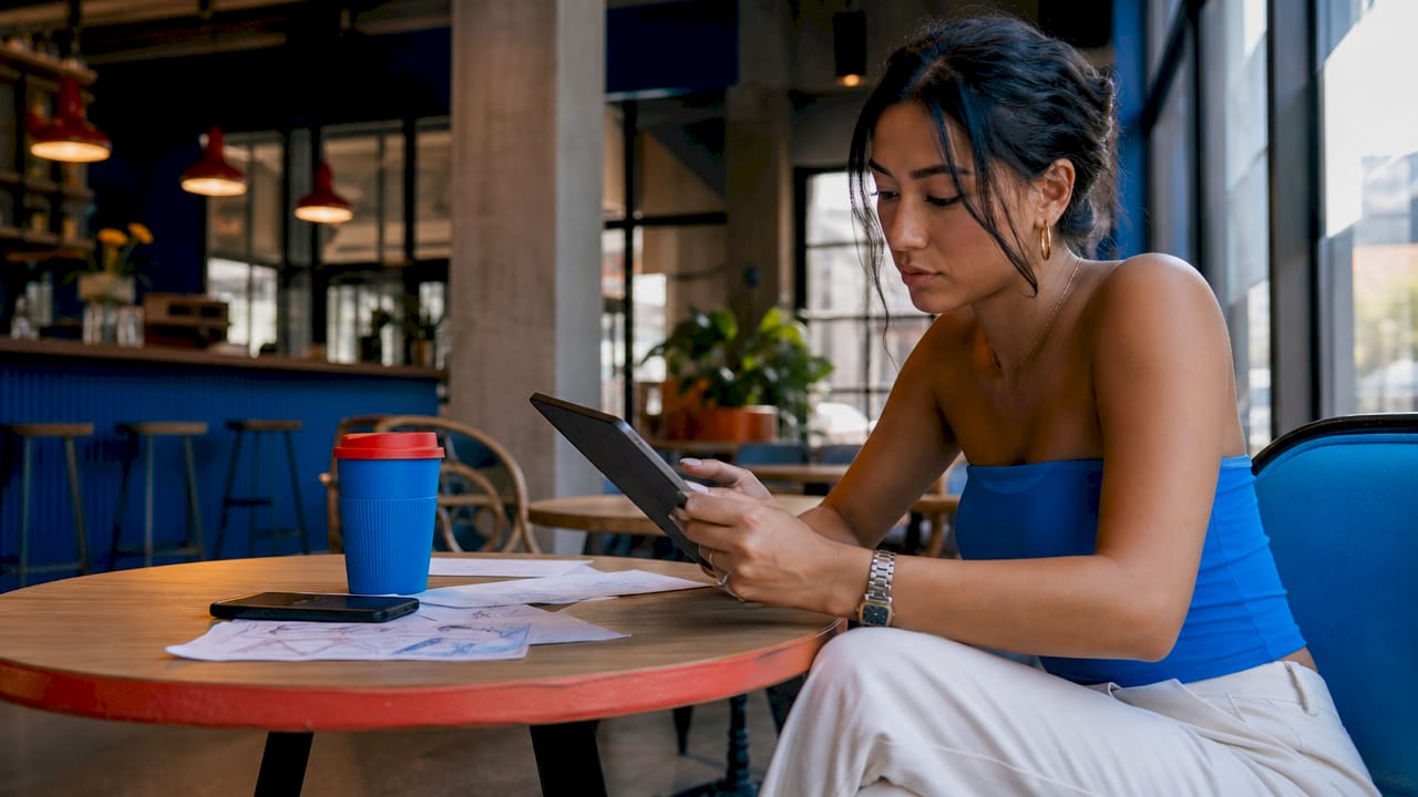 Woman scrolling social media on tablet