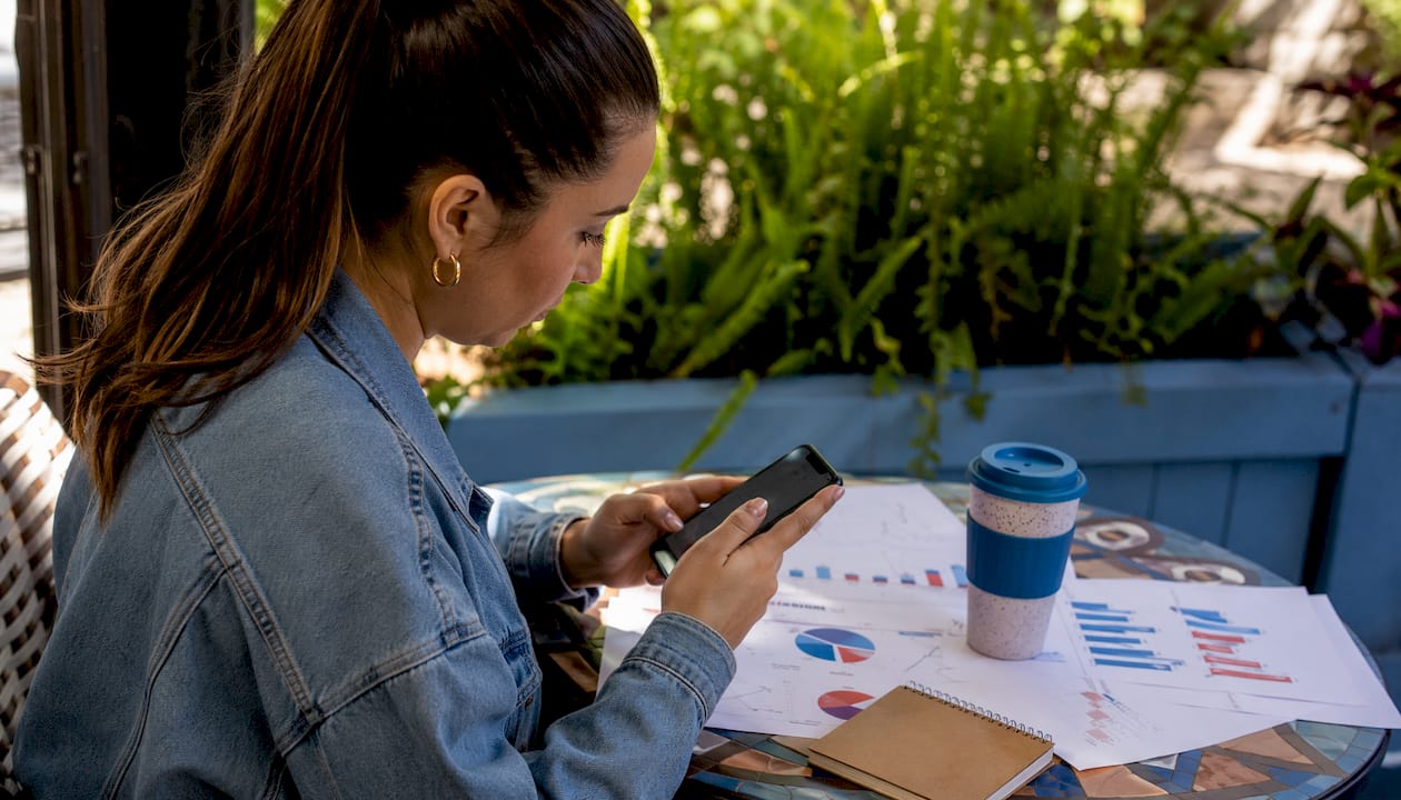 Hands comparing social media safety and targeting on desk