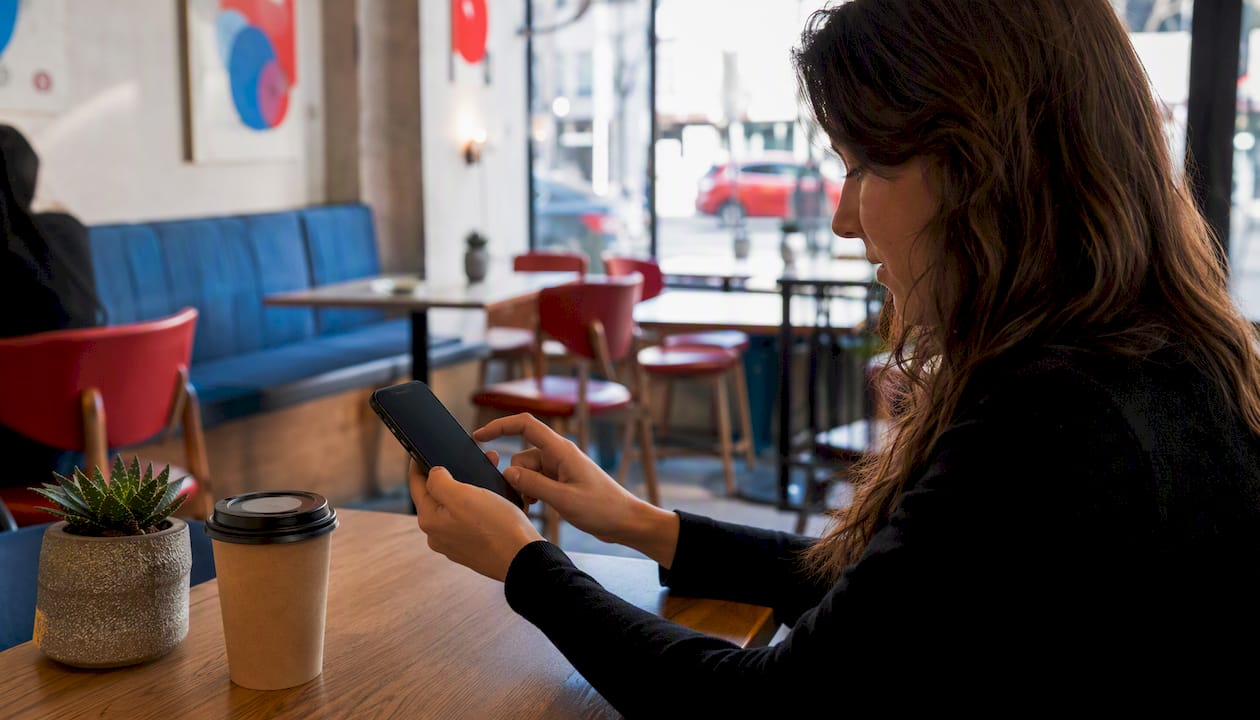 Hand replying to social media comments on phone
