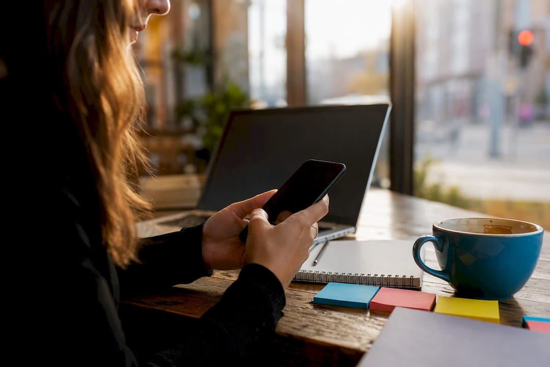 Hands vetting social media creators on phone