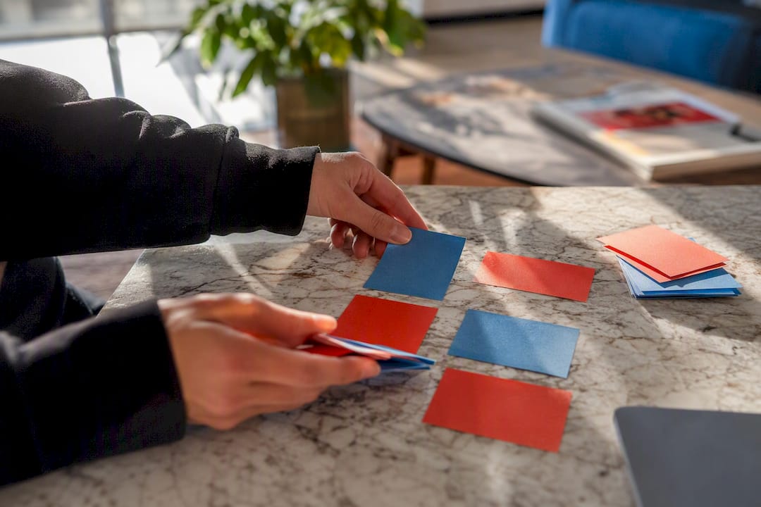 Hands organizing influencer campaign notes on table