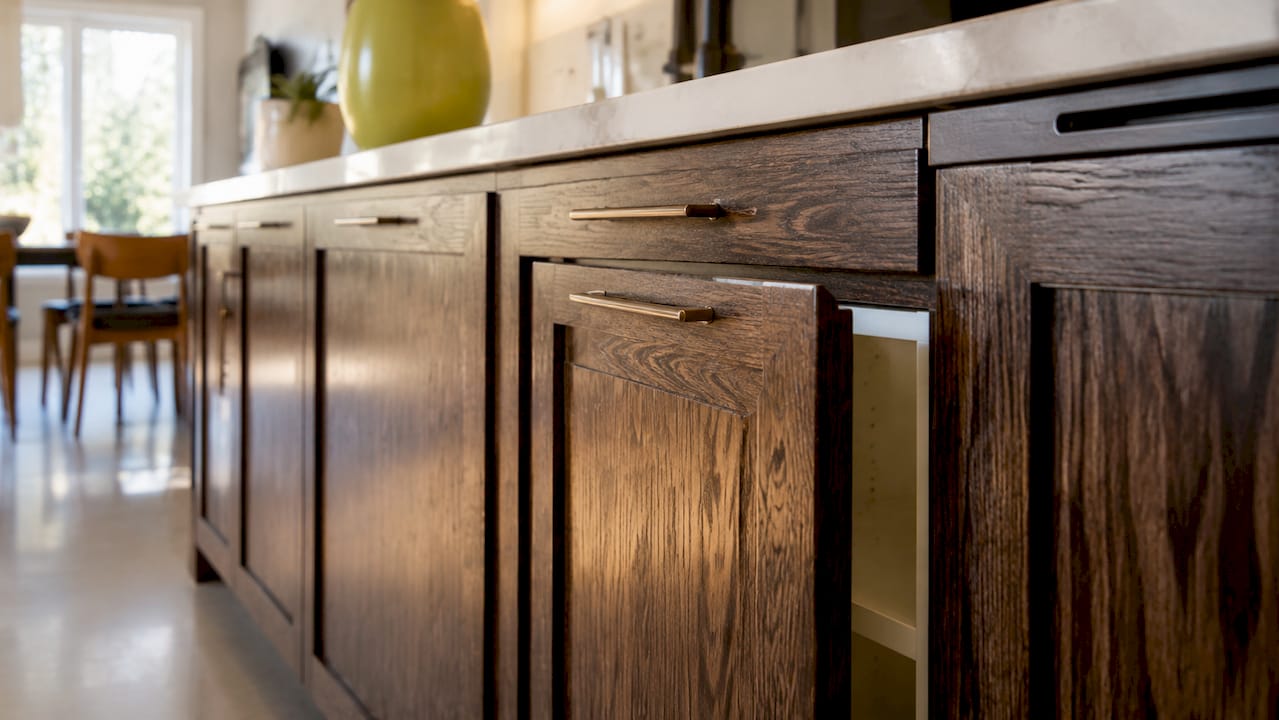 Close-up of stained wood grain on kitchen cabinet
