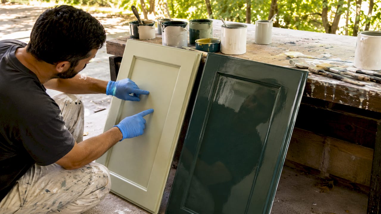 Hands testing drying vs cured cabinet paint surfaces