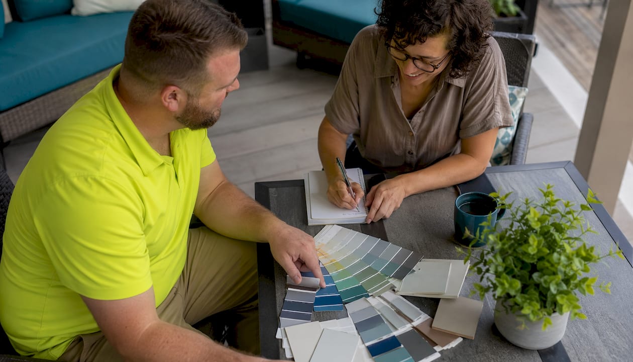 Homeowner discussing cabinet painting plans with local painter