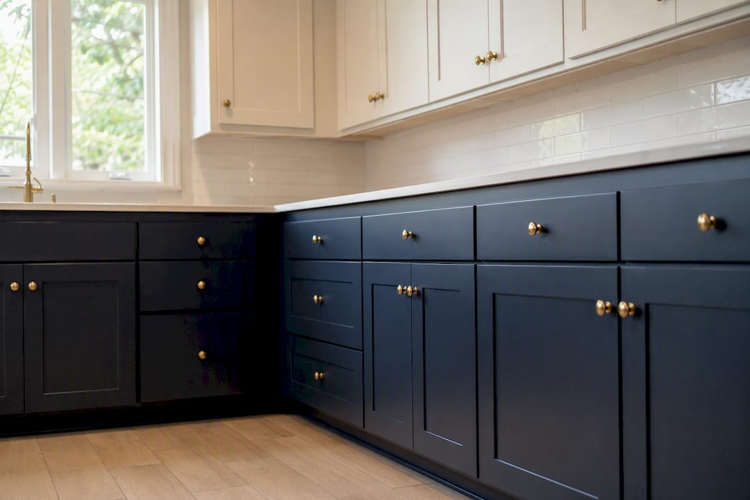 Two-tone small kitchen with navy lower cabinets