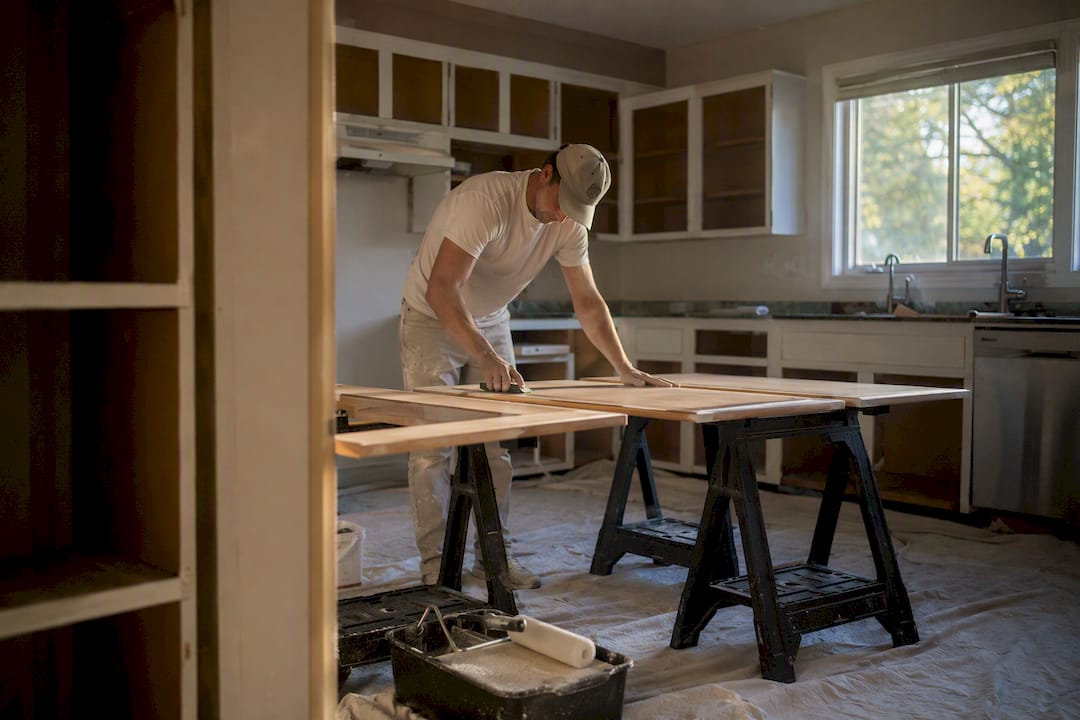 Hands sanding laminate cabinet door