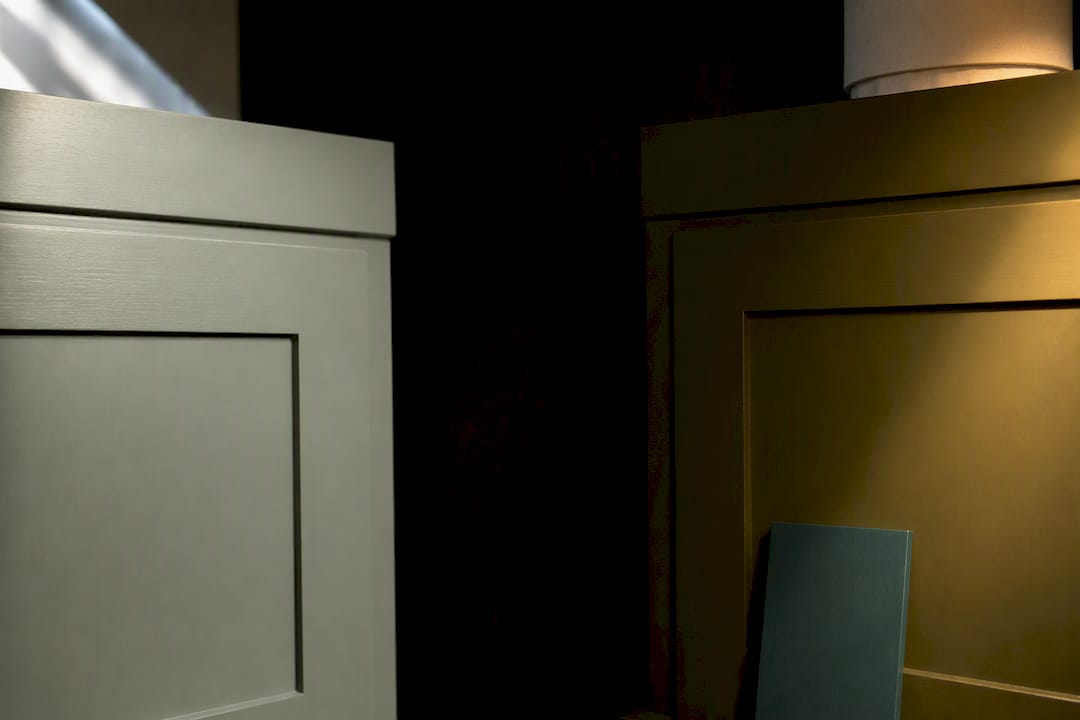 Sage and olive cabinet finishes under changing light