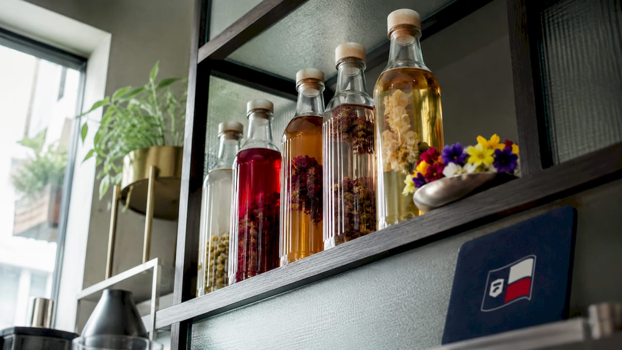 Bottles of floral syrups stored in pantry