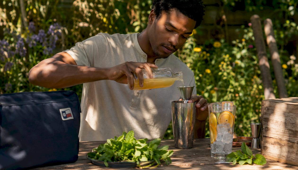 Man mixing yuzu syrup cocktail in café bar
