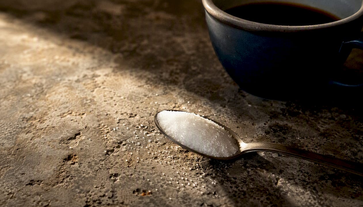 Teaspoon measuring granulated sugar close-up