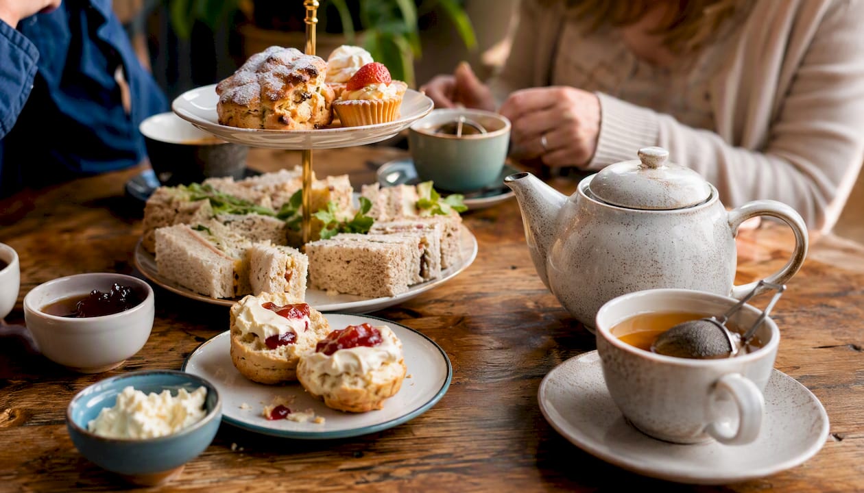 Classic British afternoon tea spread on wooden table