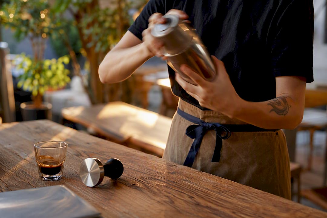 Shaking iced espresso with syrup
