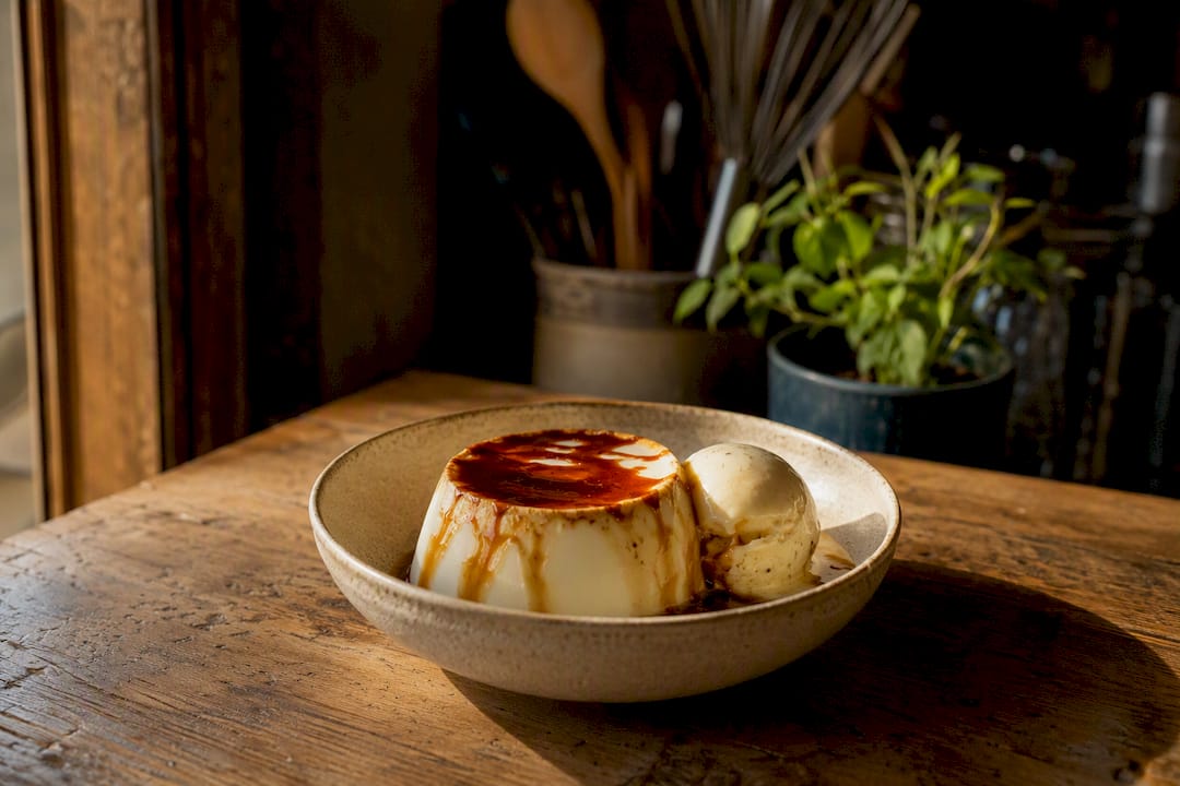 Coffee syrup drizzled over ice cream and panna cotta