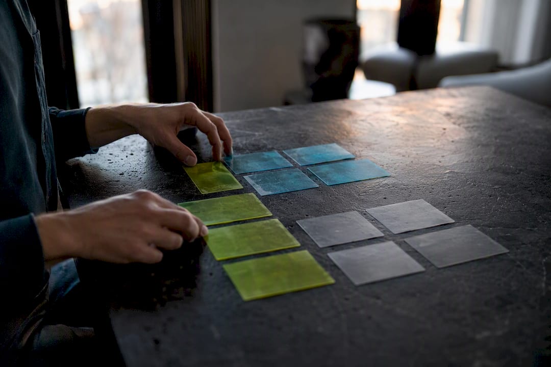 Hands arranging color-coded customer profile cards