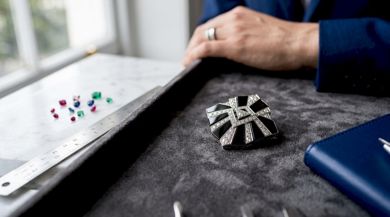 Macro of geometric Art Deco brooch with jeweler tools