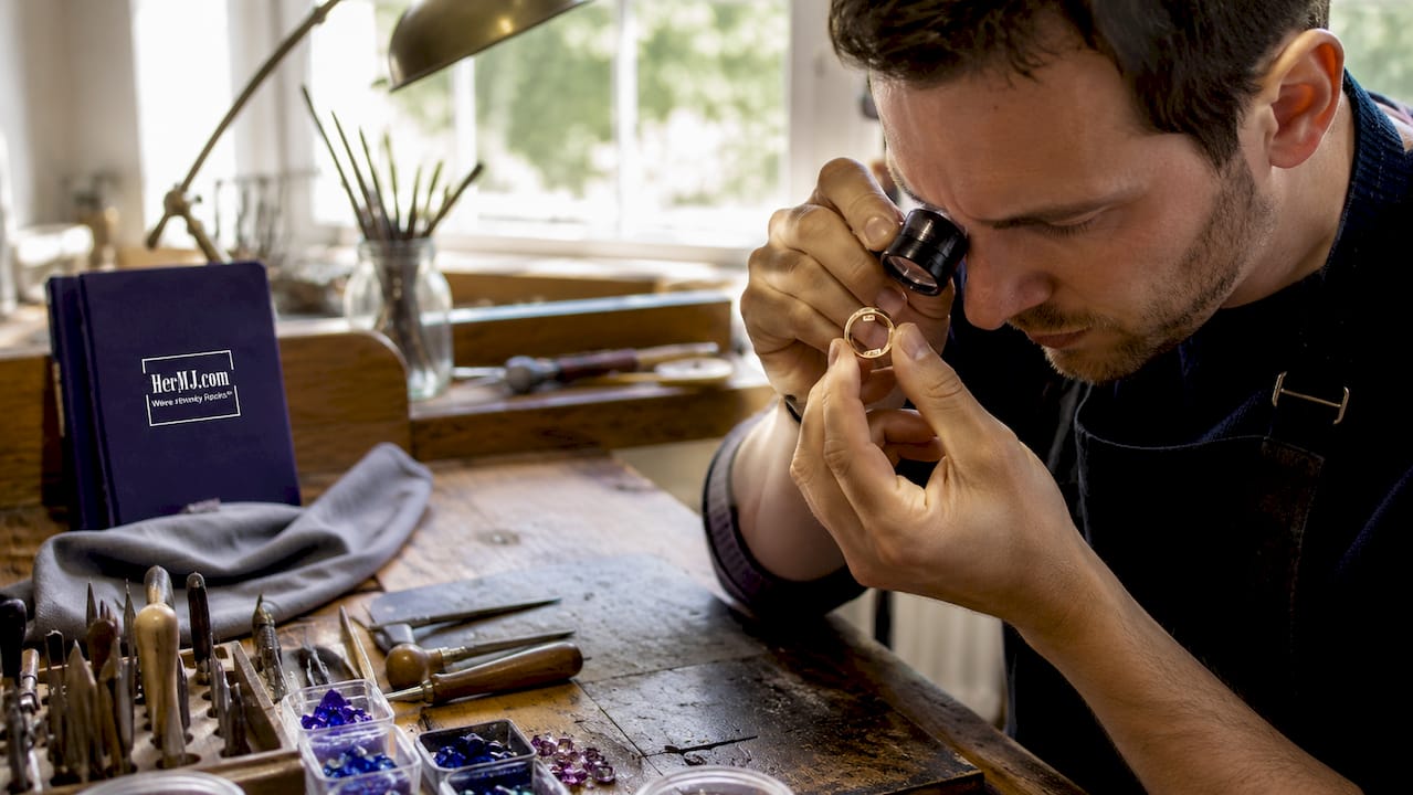 What Makes Jewelry Unique: A Complete Style Guide Hands inspecting gold ring hallmark closely