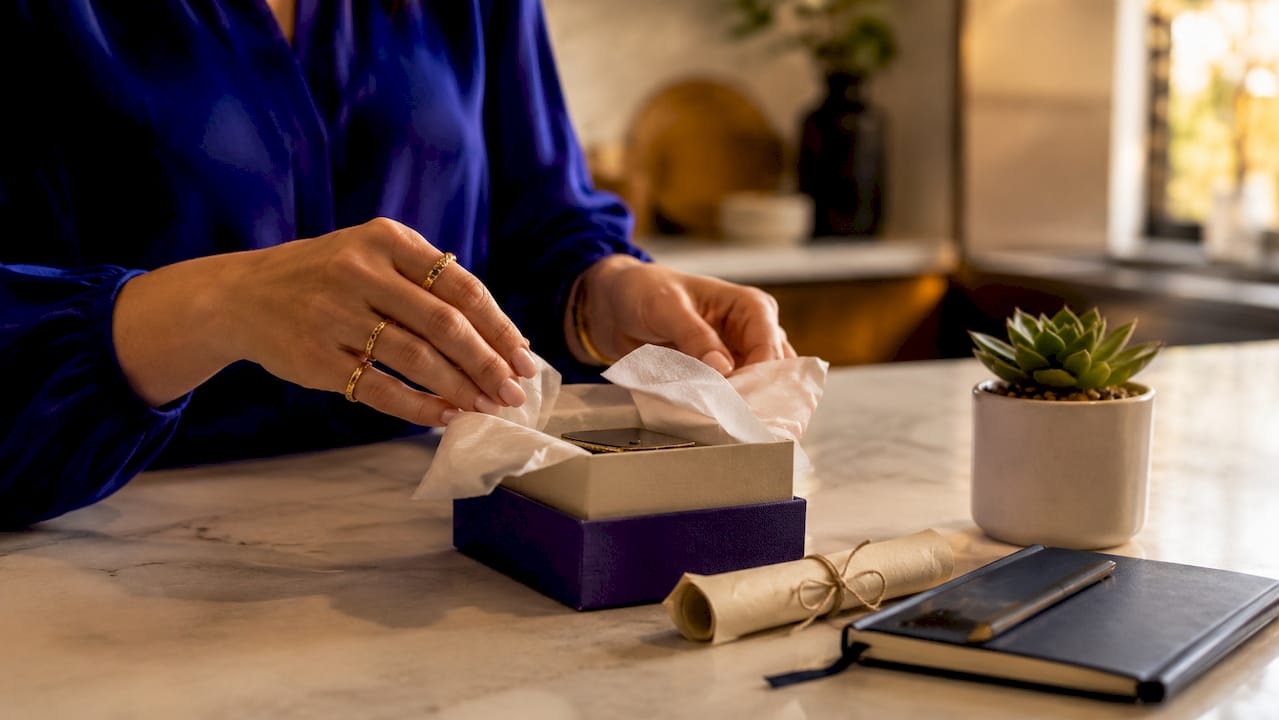 Why Handmade Jewelry Can Be Affordable for Every Budget Hands unboxing artisan jewelry at home