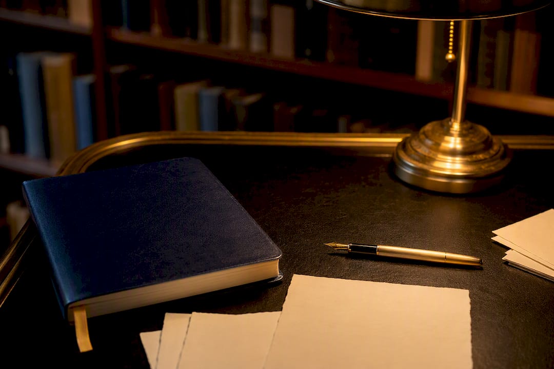 Vintage pen and notebook on desk