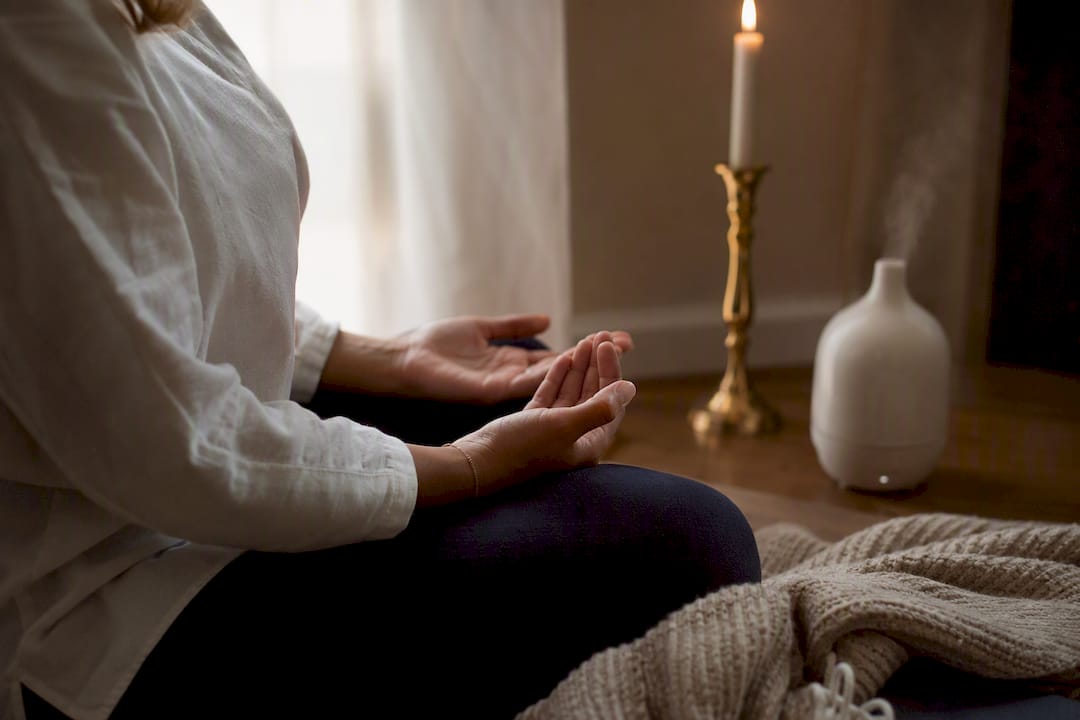 Hands clasped in calm breathing exercise