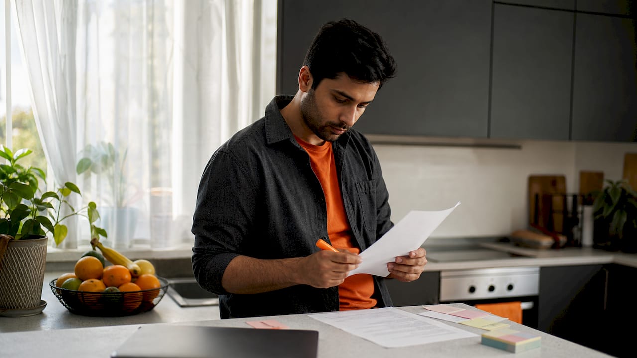 Man preparing CV for ATS screening in coworking space