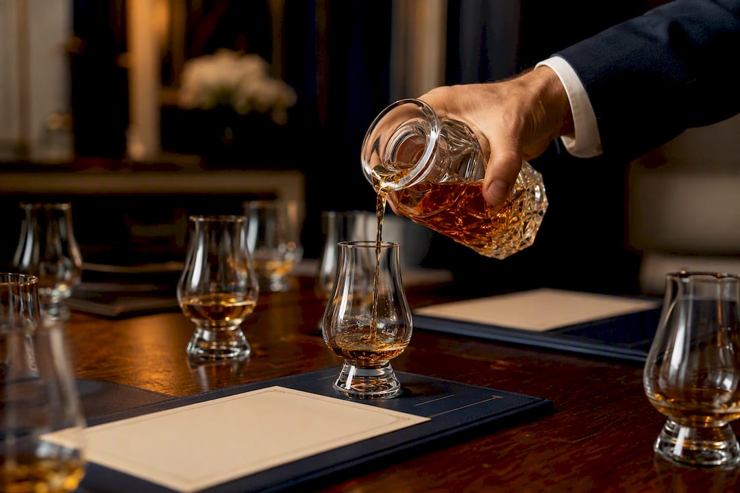 Hand pouring drink at tasting workshop