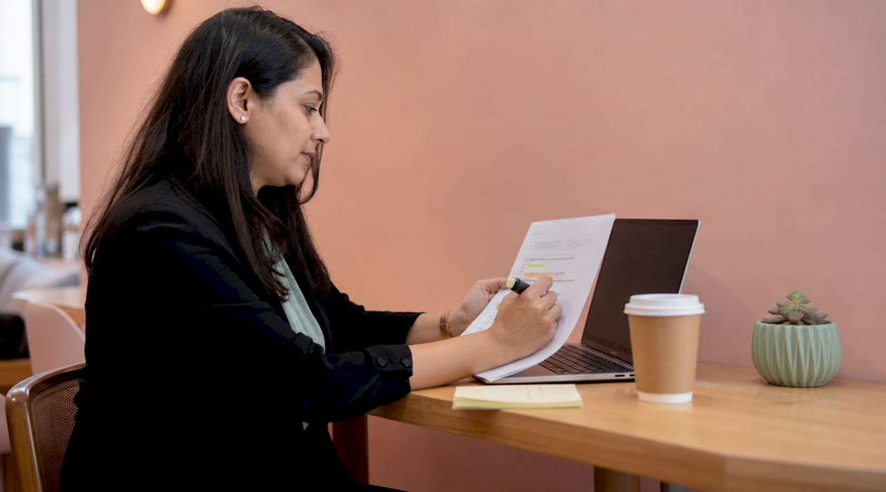 Woman reviewing trade business visibility checklist