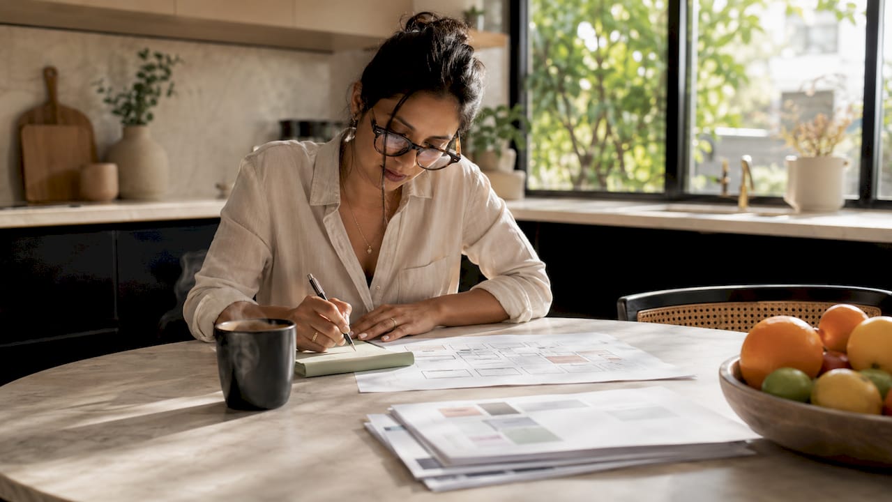 Woman planning SME website redesign at desk