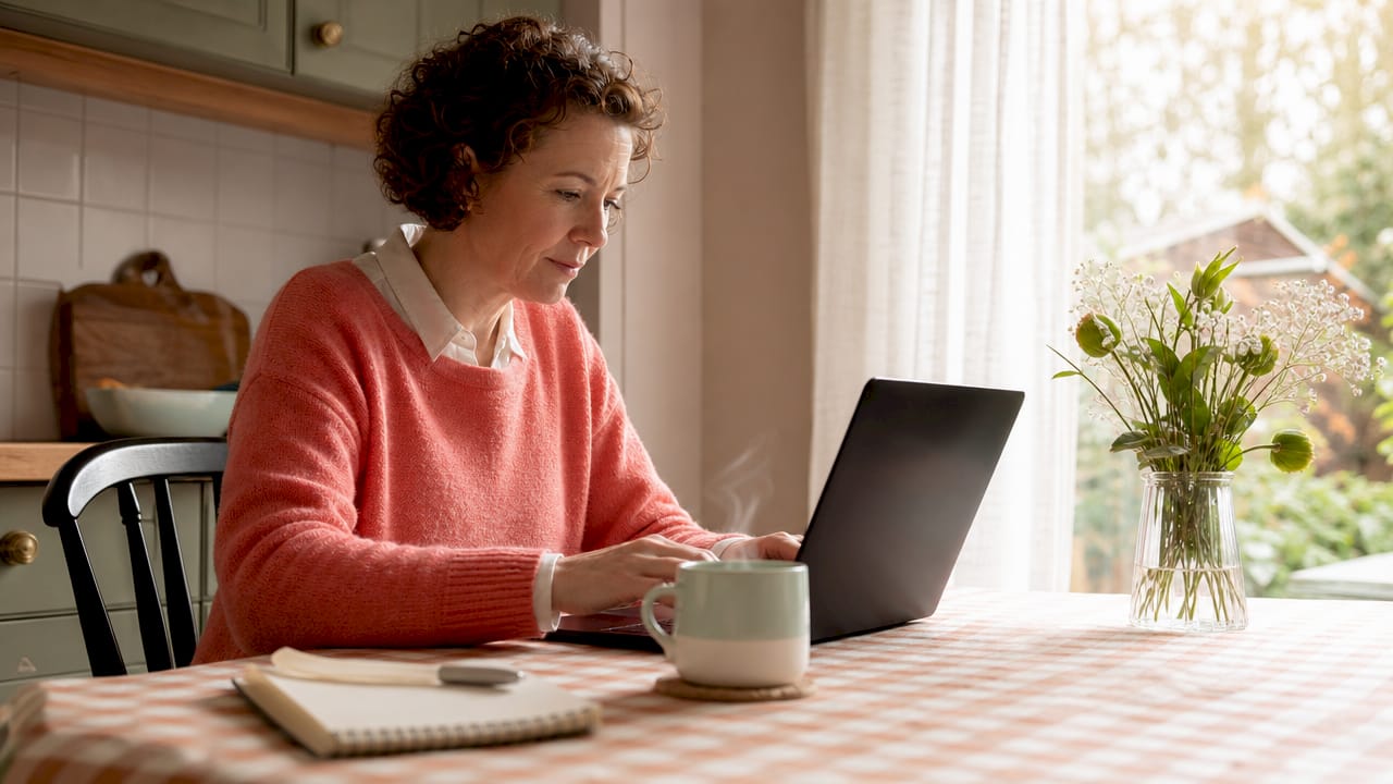 Woman submitting online enquiry form at desk