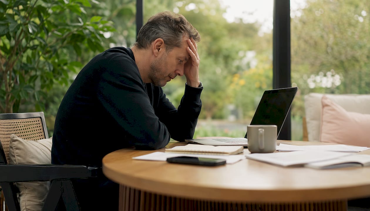 Frustrated man at slow website on laptop