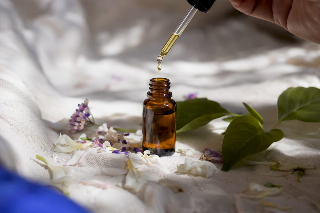Botanical oil dropper with fresh plant leaves