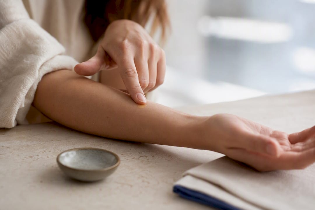 Testing facial oil on inner forearm