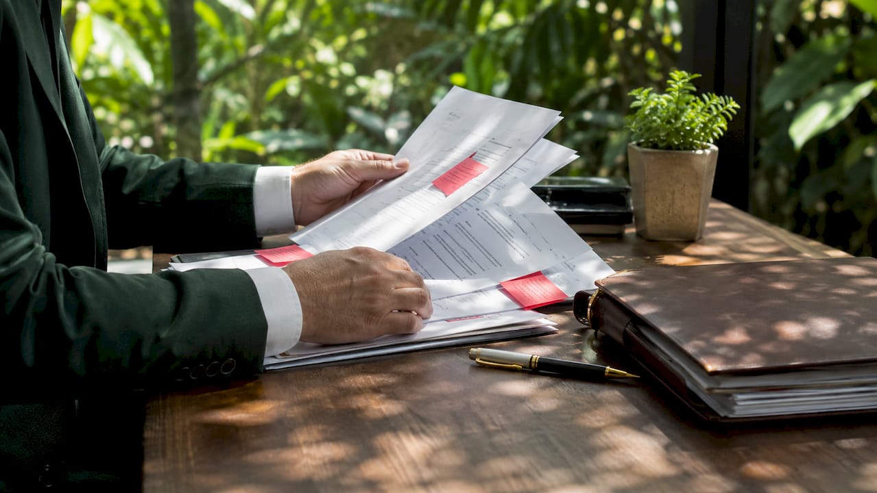 Hands sorting legal counterclaim paperwork