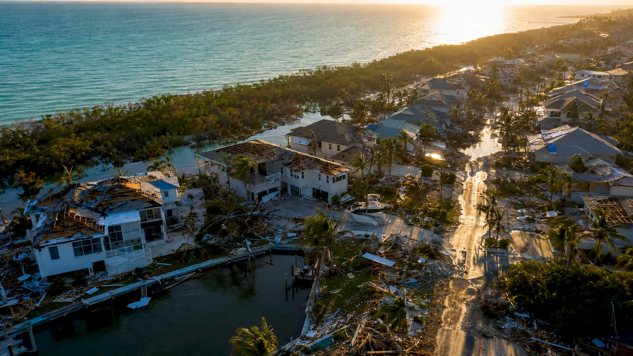 Why Naples Real Estate Values Need Protection Now Aerial of Naples neighborhood with hurricane damage