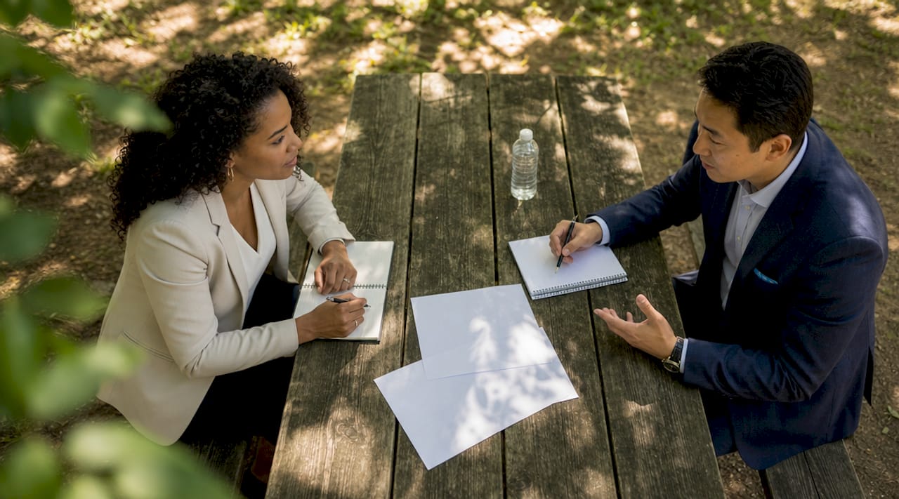 Two professionals negotiating estate settlement