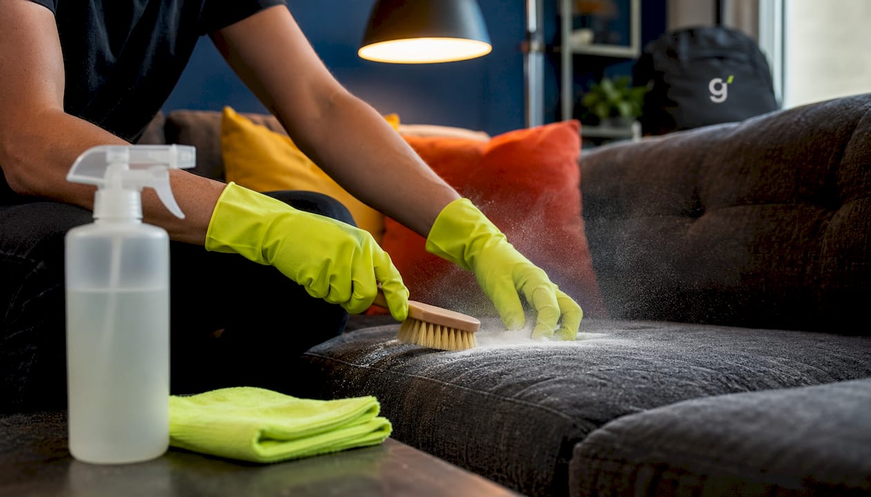 Hands applying natural fabric cleaning agents