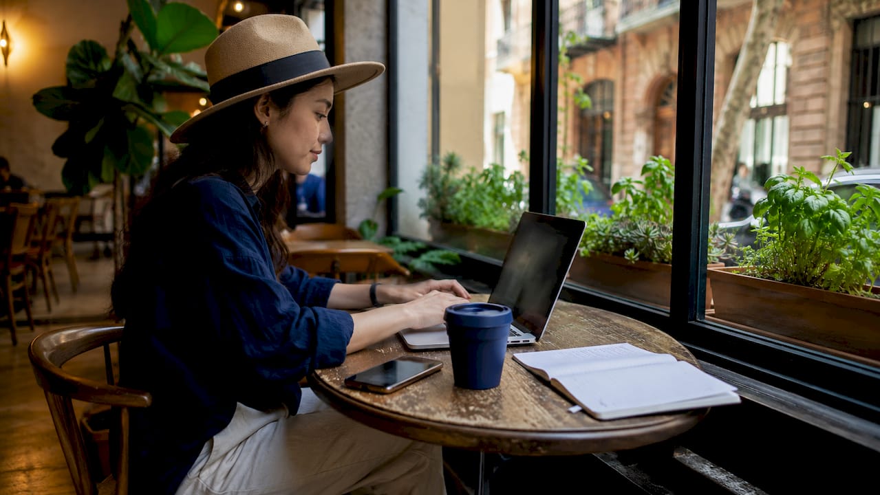 Young woman working remotely in Barcelona co-working space