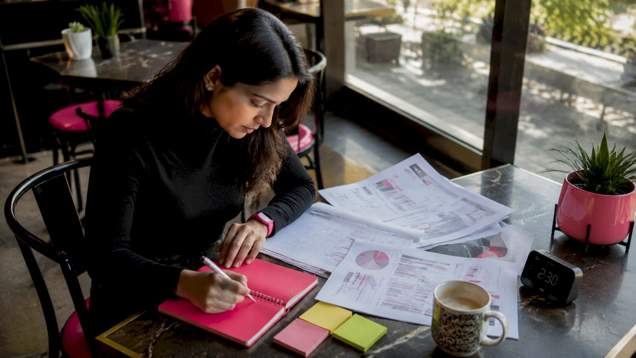 Woman reviewing website audit reports at desk