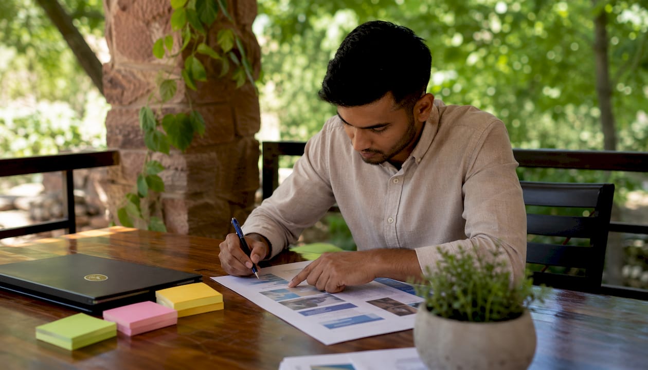 Agent marking CMA chart at coworking table
