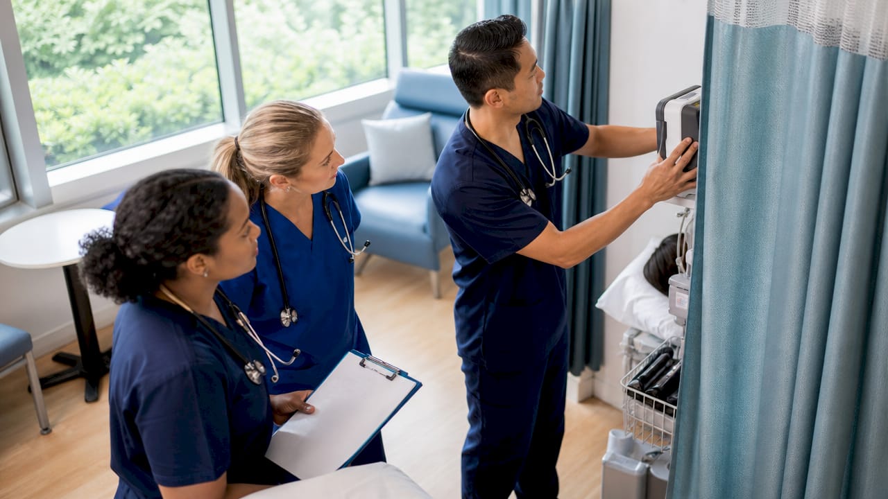 Nurses collaborating in hospital corridor during shift