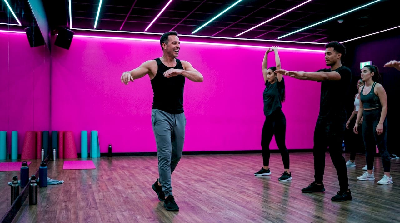 Instructor leading warm-up exercises in class