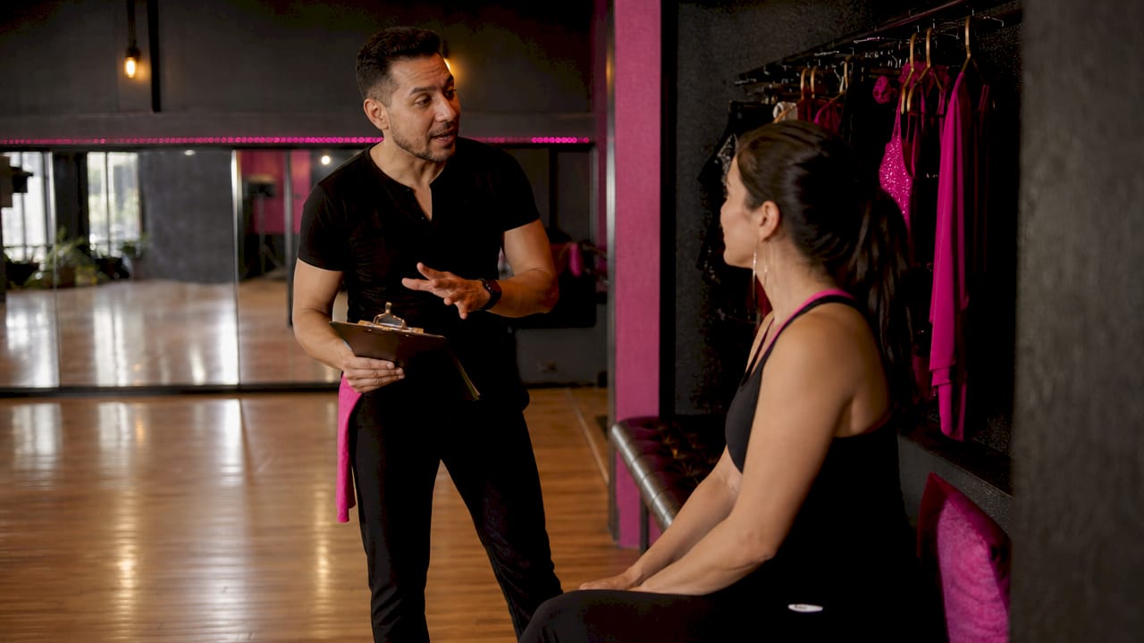 Dance instructor discussing credentials with student